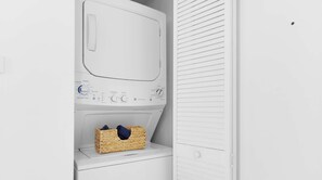 A white laundry room with a washing machine, a dryer, and a wicker basket on the floor. - High-Floor Balcony · 2BR Resort Sunset View (Hallandale Beach)