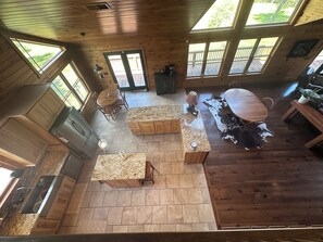 A spacious kitchen with wooden cabinets, a granite countertop, and a dining area with a large table and chairs.