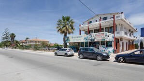 A building with a sign for 'Travenure' and 'General Travel Agency.' - Artemis Studio Apartment in Laganas, Zante with Sea Activities (Laganas)