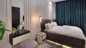 Deluxe Apartment, Balcony, City View | In-room safe, desk, laptop workspace, blackout drapes