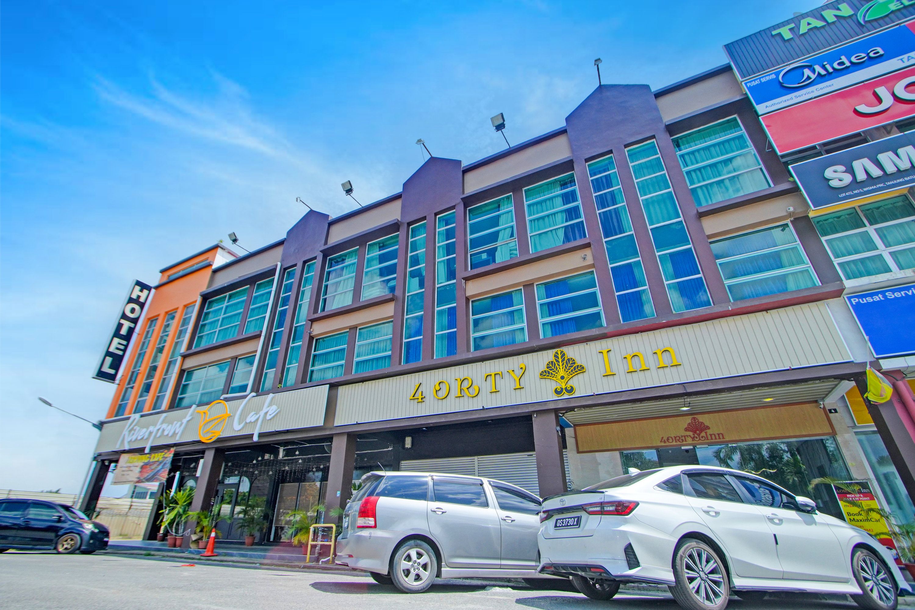 A hotel with a prominent sign for 'Forty & Inn' and a visible car parked in front.