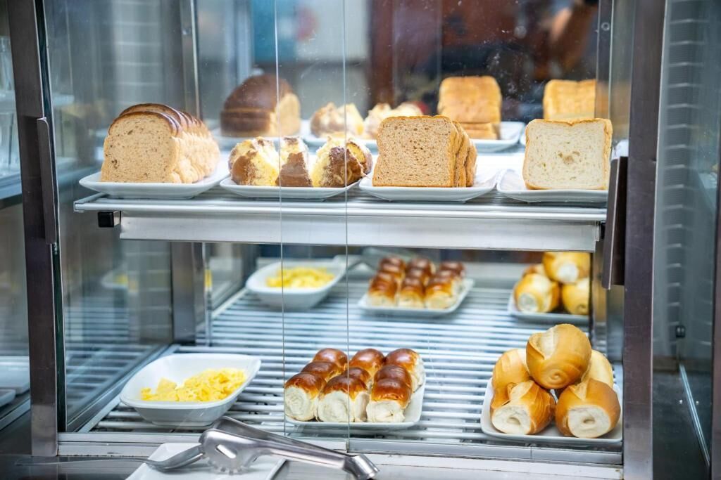 A bakery display case with various breads and pastries.