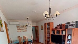 A living room with two sofas, a coffee table, a TV, and a bookshelf. - Nice Apartment Near the Beach With Parking and Wifi (Roquetas de Mar)