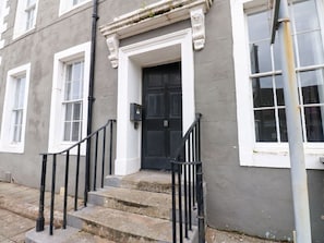 A building with a black door, white-framed windows, and a stone staircase with black railings. - Lowther Apartment, Whitehaven (Whitehaven)