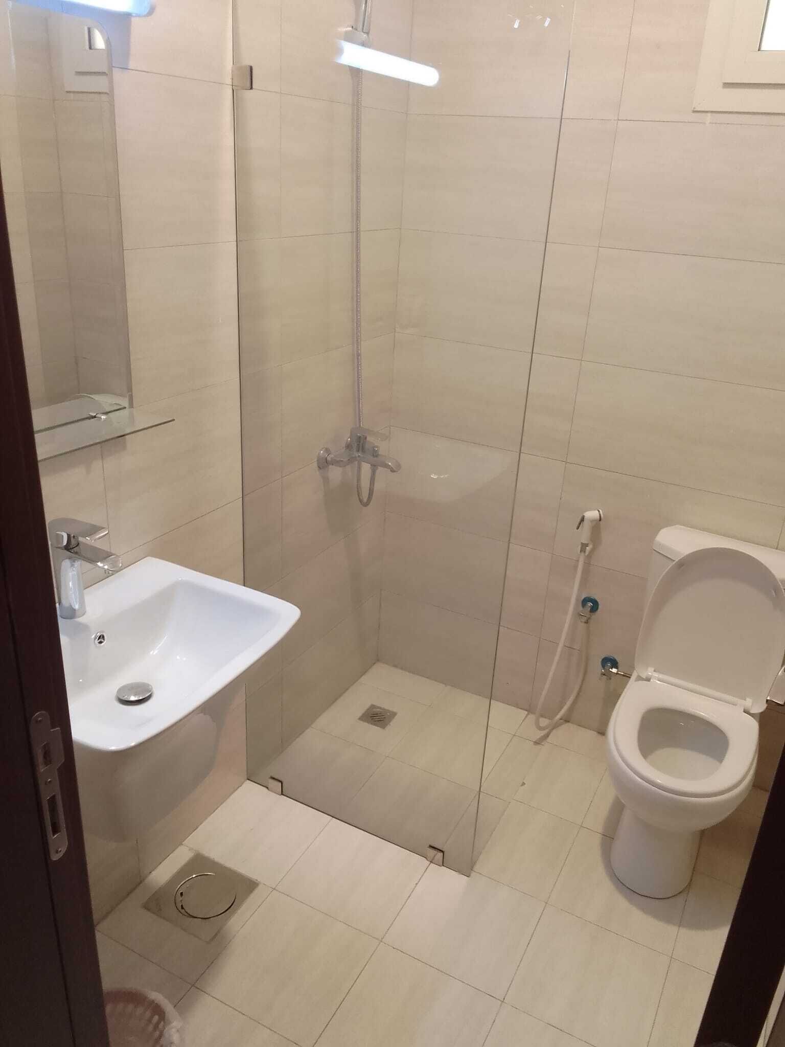 A bathroom with a sink, toilet, and shower.
