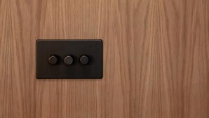 A thermostat and a control panel on a wooden wall. - Normandy Court 11 (London)
