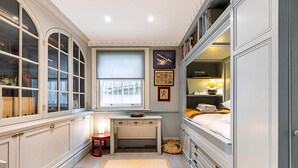 A narrow room with a window, a desk, and a bed. - Elegant Highgate Garden Retreat (London)