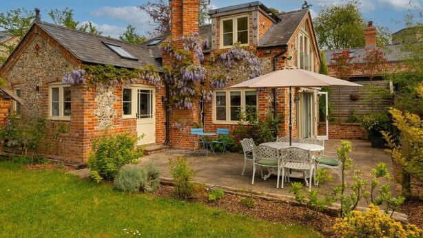 A brick house with a garden patio, a covered seating area, and a chimney. - The Stag in the Chiltern Hills (Fawley)