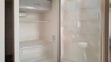 An open refrigerator with a control panel, a freezer compartment, and a water dispenser.