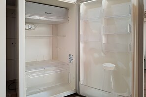 An open refrigerator with a control panel, a freezer compartment, and a water dispenser. - SHB - Entre a Praia e o Mundo Disney (Santos)