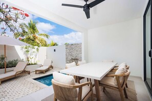 A modern outdoor patio with a pool, lounge chairs, and a dining table. - New CHIC 2BR Villa, Walk to Beach! Pool & Terrace (Lower Carlton)