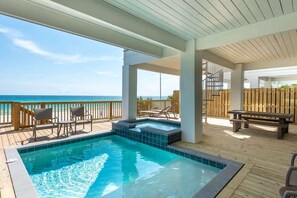 A pool area with a hot tub, wooden deck, and chairs, overlooking the ocean. - Gulf-Front Luxury Home with Private Pool, Beach Access & Bikes! (Panama City Beach)