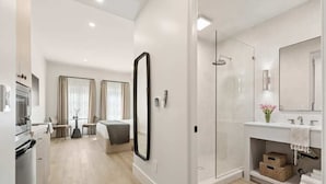 A modern bathroom with a glass shower, a large mirror, and a white sink. - Casa Iglesia Studio 205 (Santa Barbara)