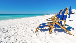 A beach with white sand and a clear blue sky. - Ariel Dunes I 610- Emerald Eden (Miramar Beach)