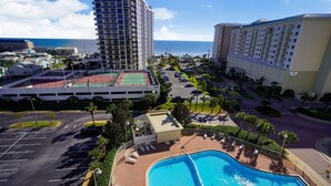 A hotel with a pool, a tennis court, and a view of the ocean. - Ariel Dunes I 801- Morning Raes (Miramar Beach)