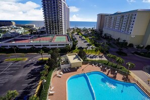 A hotel with a pool, a tennis court, and a view of the ocean. - Ariel Dunes I 801- Morning Raes (Miramar Beach)