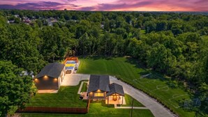 A residential area with houses, a well-maintained lawn, and a soccer field. - The Stadium by Mercer Stays | Private 2.2Acre Sports Estate for Teams & Families (Saint Charles)
