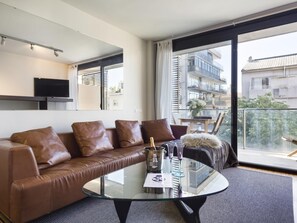 TV, books - Immerse in Barcelona – 2 & 3 Bedroom Units with Terrace Options (Barcelona)