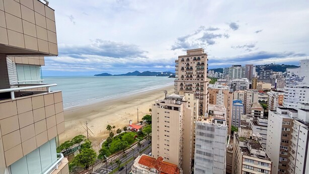 A coastal cityscape with high-rise buildings, a beach, and a clear sky. - SHB - Beach Vibe Estilo Vista Mar Sacada (Santos)