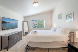 A bedroom with a bed, dresser, window, and artwork on the walls. - Large Group Escape,  5 Beds, Pets Welcome (Reno)