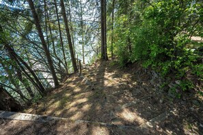 A forested hiking trail with a wooden staircase leading up. - Waterfront Sandbar Point w/ Dock Access & Nearby Activities (Hayden)