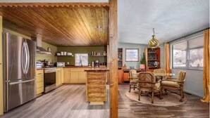 A kitchen with wooden cabinets, a stainless steel refrigerator, and a dining area with wicker chairs and a round table. - Creekside retreat + hot tub near Sedona (Cornville)