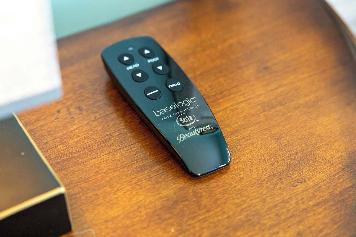 A remote control on a wooden surface.