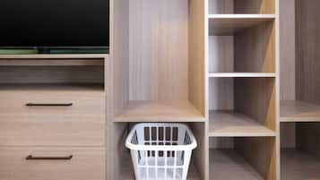 A wooden wardrobe with two drawers and a hanging laundry basket.