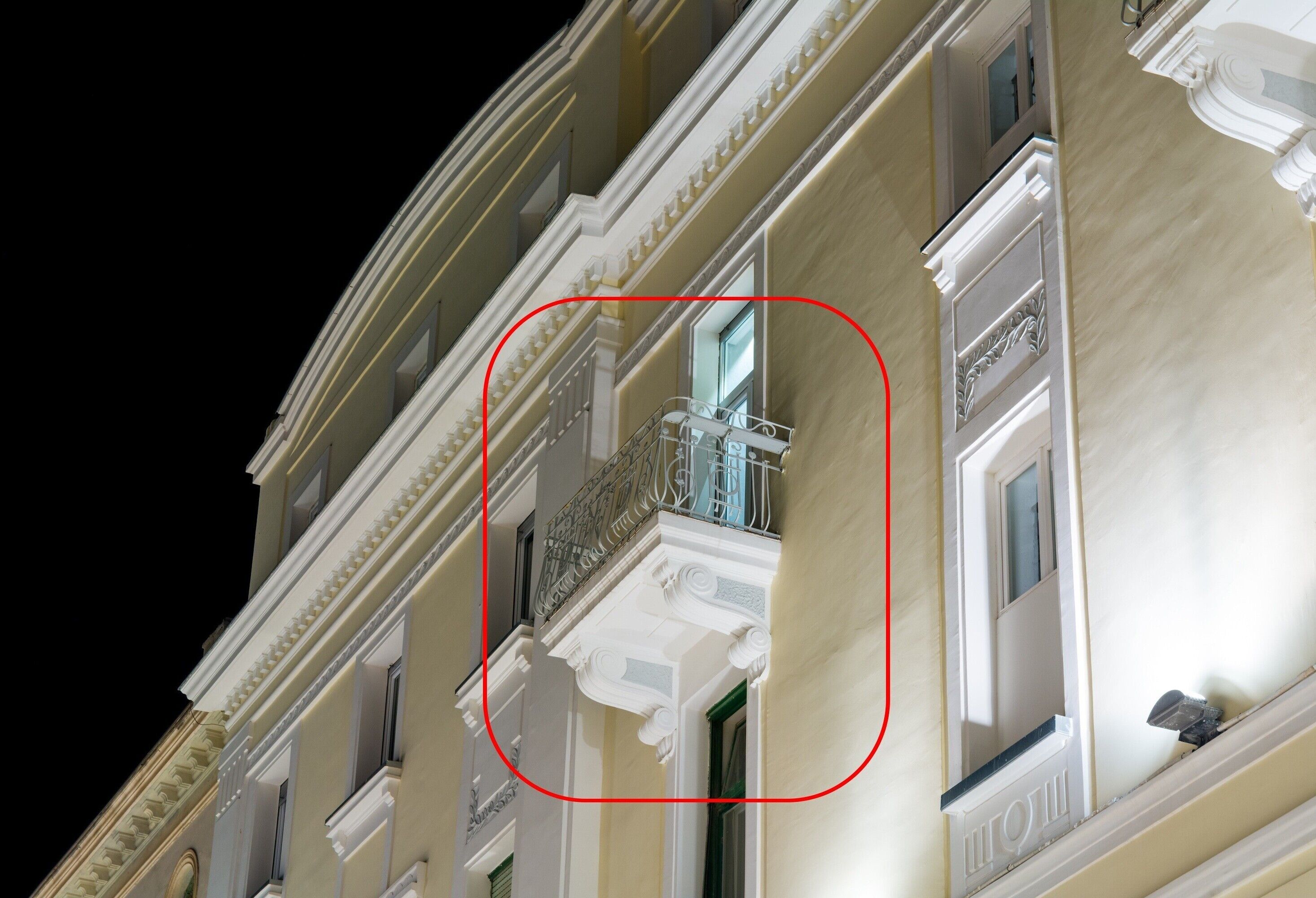 A building facade with classical architecture, including columns and decorative moldings.