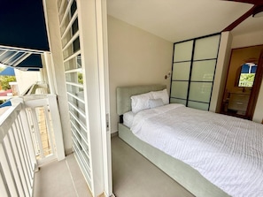 A bedroom with a bed, a window, and a balcony. - Beachfront, Ocean Views & Renovated Spaces (Dorado)