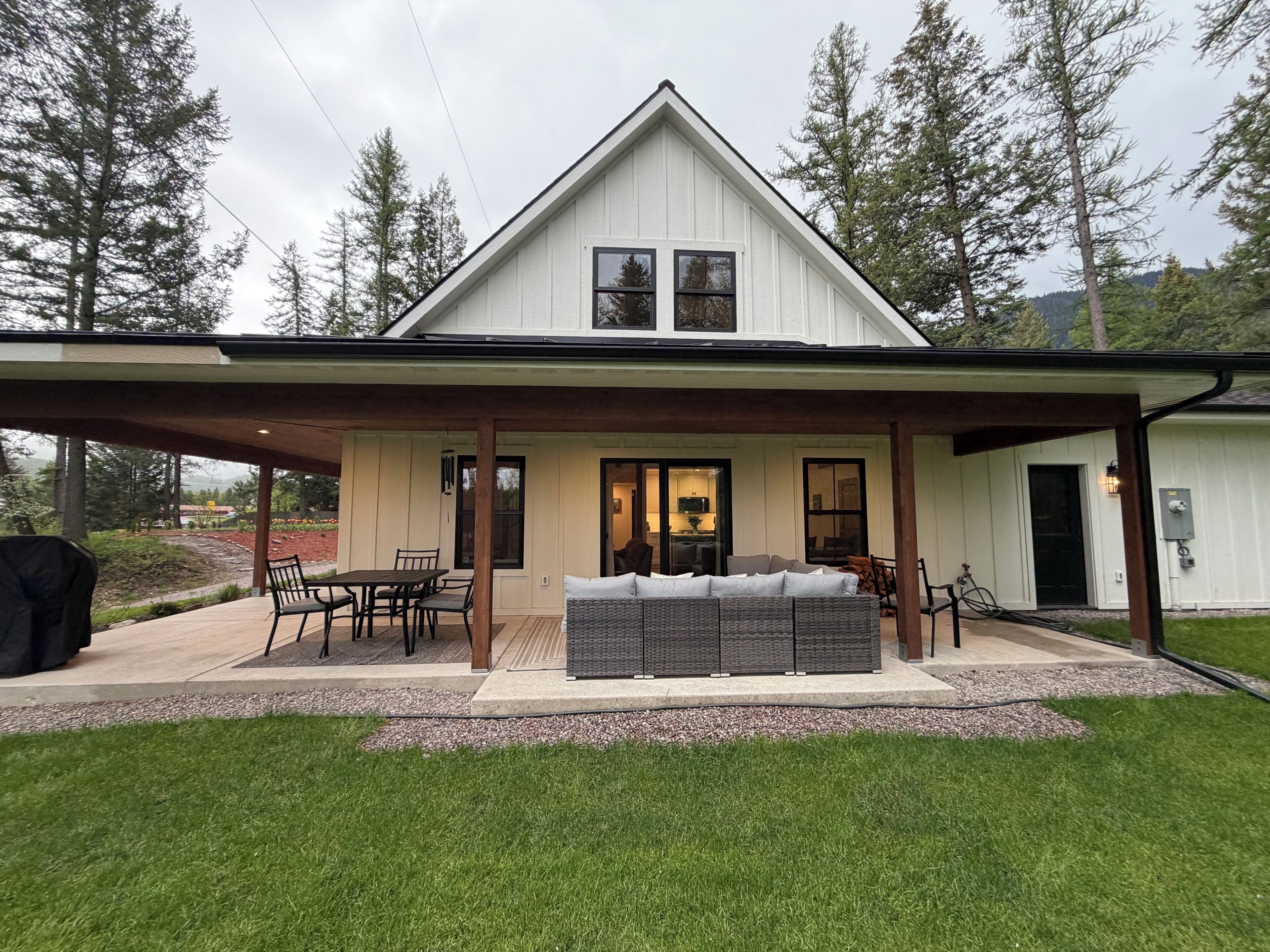 A house with a covered patio, a dining area, and a seating area.