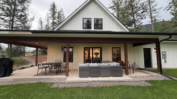 A house with a covered patio, a dining area, and a seating area.