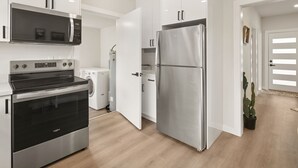 A modern kitchen with stainless steel appliances, a built-in oven, and a refrigerator. - Beautiful 3-bedroom house in wonderful Bellingham for your getaway (Bellingham)