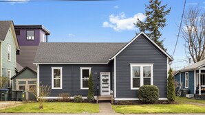 A residential house with a grey exterior, white trim, and a front porch. - Beautiful 3-bedroom house in wonderful Bellingham for your getaway (Bellingham)