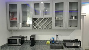 A kitchen with a microwave, coffee maker, and dish rack.