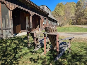 A rustic building with a porch and wooden chairs. - The Sugarhouse in Dummerston, Vermont (Dummerston)