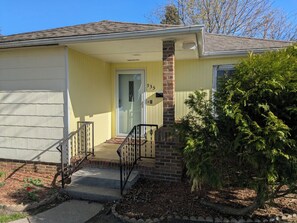 A single-story house with a front porch, a brick column, and a mailbox. - Completely updated 2-bedroom house in Fairmont with garage (Fairmont)