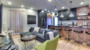 A modern apartment with a living area, kitchen, and dining space. - Stylish 5BR in Plateau Sleeps 10 (Montreal)
