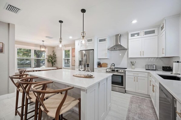 Bright, open kitchen with a spacious island, generous seating, and everything your group needs to cook and gather comfortably.