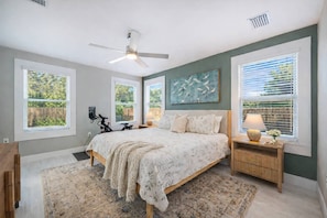 Rest comfortably in the spacious primary bedroom, featuring a king bed, soft linens, a Smart TV, and peaceful natural light. - Three Little Birds | Historic Luxury Retreat (Lakeland)