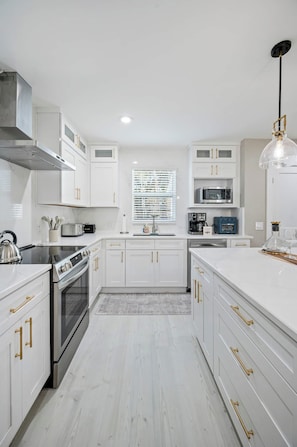 A clean, fully equipped kitchen with abundant counter space, modern appliances, and plenty of room for preparing family meals.
