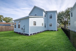 The home includes a grassy outdoor area, giving guests additional space to enjoy the Florida sunshine.