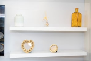 Two white shelves with decorative items.