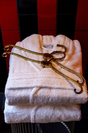 A white towel with a golden hairpin on it.