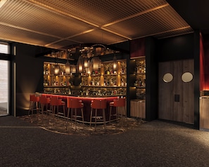 A bar area with a high ceiling, multiple hanging light fixtures, a marble countertop, and several red bar stools. - Park Hyatt Riviera Maya - All Inclusive (Puerto Morelos)