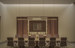 A conference room with a long table, multiple chairs, a large sofa, and a decorative wall panel. - Park Hyatt Riviera Maya - All Inclusive (Puerto Morelos)
