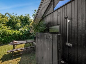 A wooden building with a window, a door, and a picnic table. - "Lasse" - 550m from the sea by Interhome (Knebel)
