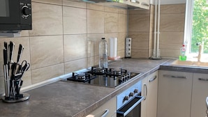 A modern kitchen with a gas stove, oven, and stainless steel appliances.