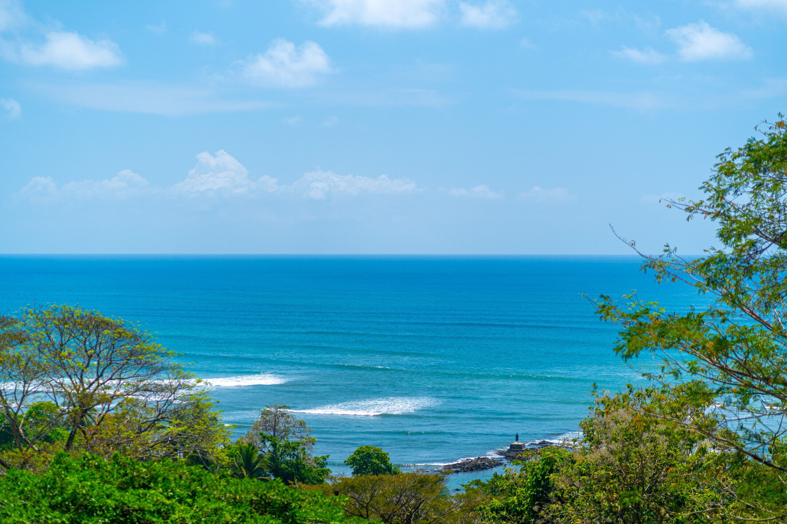 A coastal landscape with a view of the ocean and a rocky shoreline.