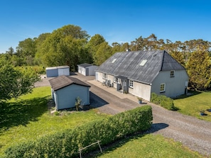 A single-story house with a sloped roof, a small attached garage, and a paved driveway. - "Aslag" - 3.5km from the sea by Interhome (Læsø)